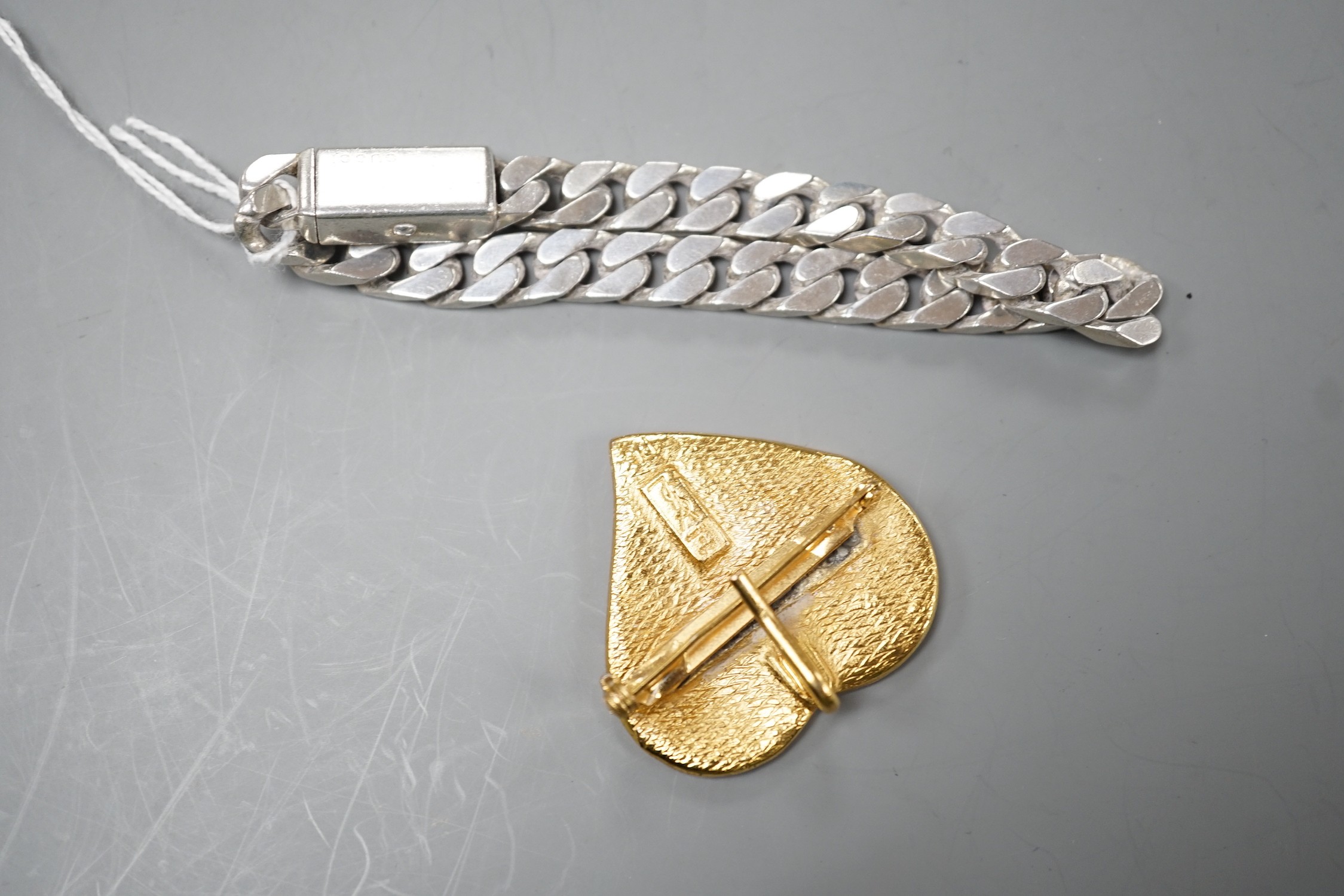 A modern Italian Gucci 925 curb link bracelet, approximately 20cm, together with an Yves Saint Laurent enamelled gilt metal heart shaped pendant brooch, 40mm.